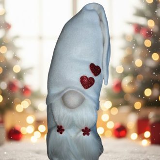   Plüss manólány, fehér sapkával, piros glitteres dekorokkal